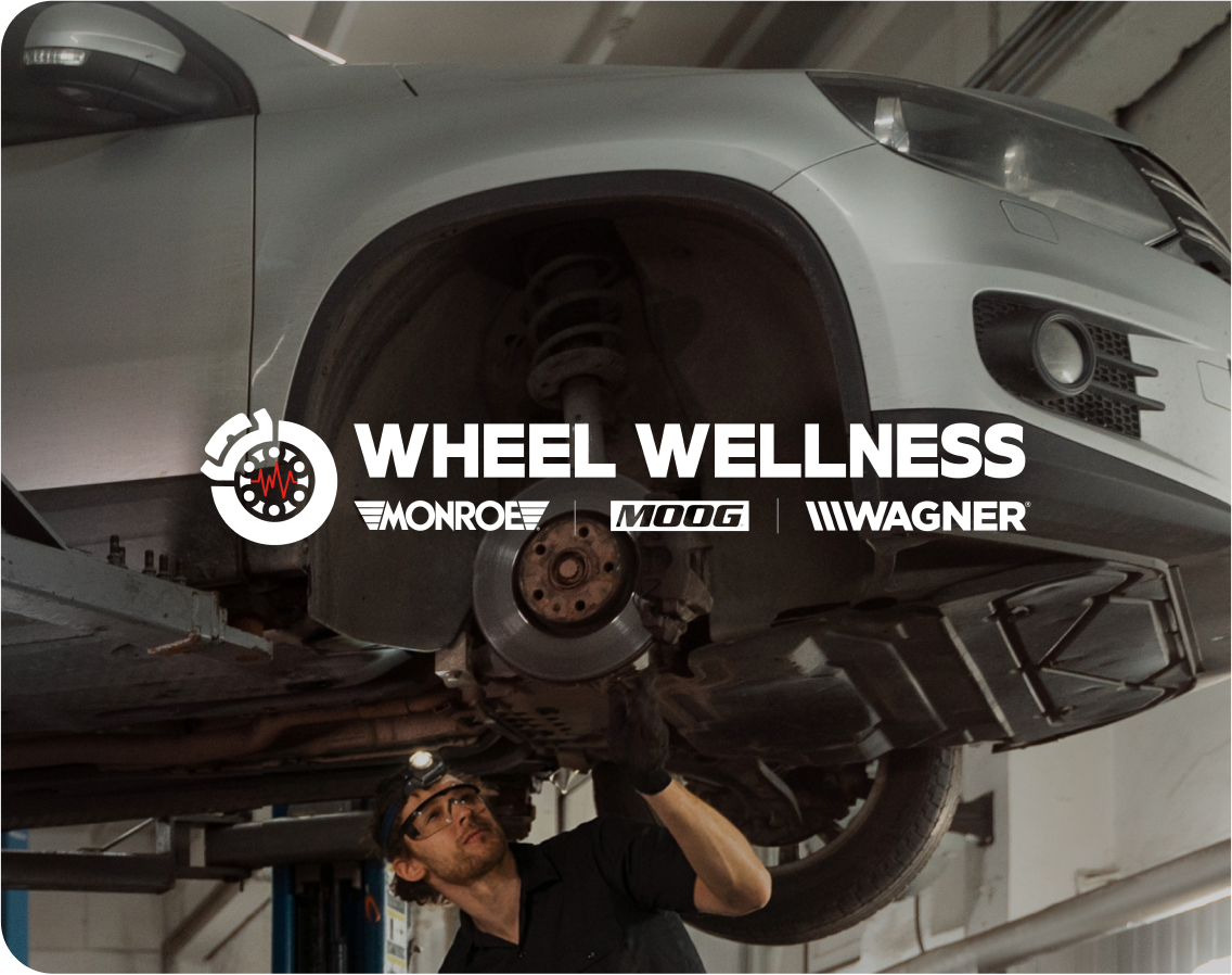 Wheel Wellness by Monroe, MOOG and Wagner — technician inspecting a vehicle's wheel and suspension