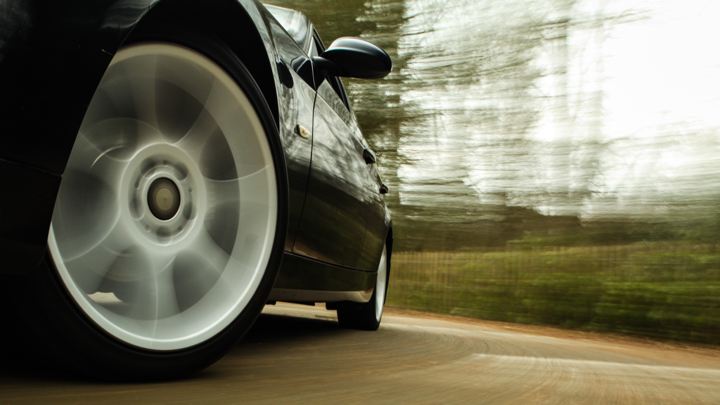 Car on road with focus on tire.