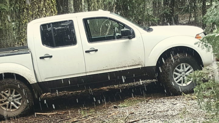 Nissan Frontier truck driving in rain.