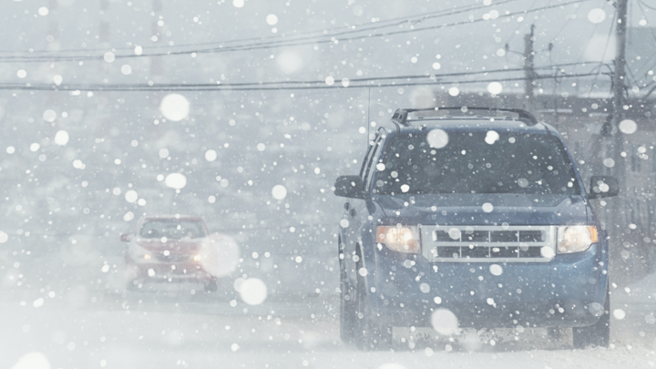 SUV driving on snpwy road.