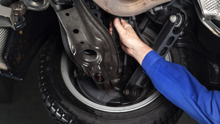 Mechanic inspecting shocks