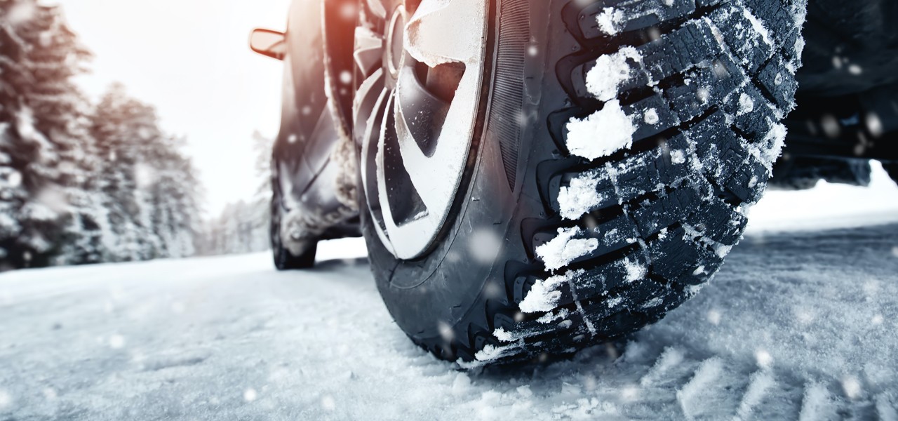 winter-vs-shocks-struts-hero Car tire on snow.