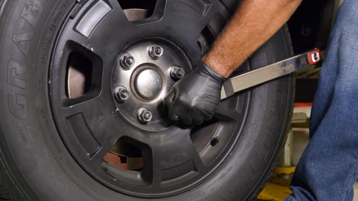 Technician torquing the wheel lug nuts