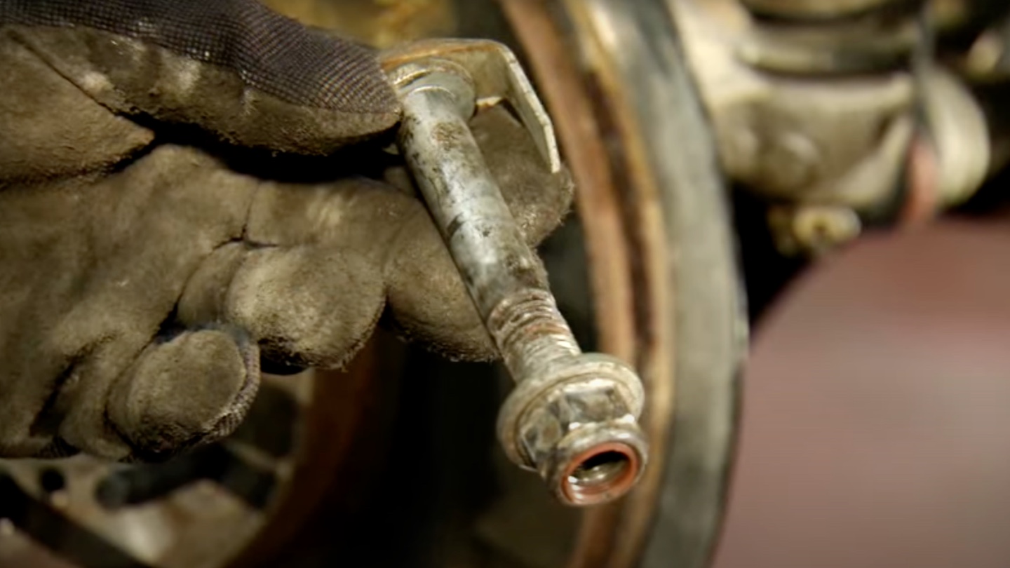 Technician Holding Suspension Hardware